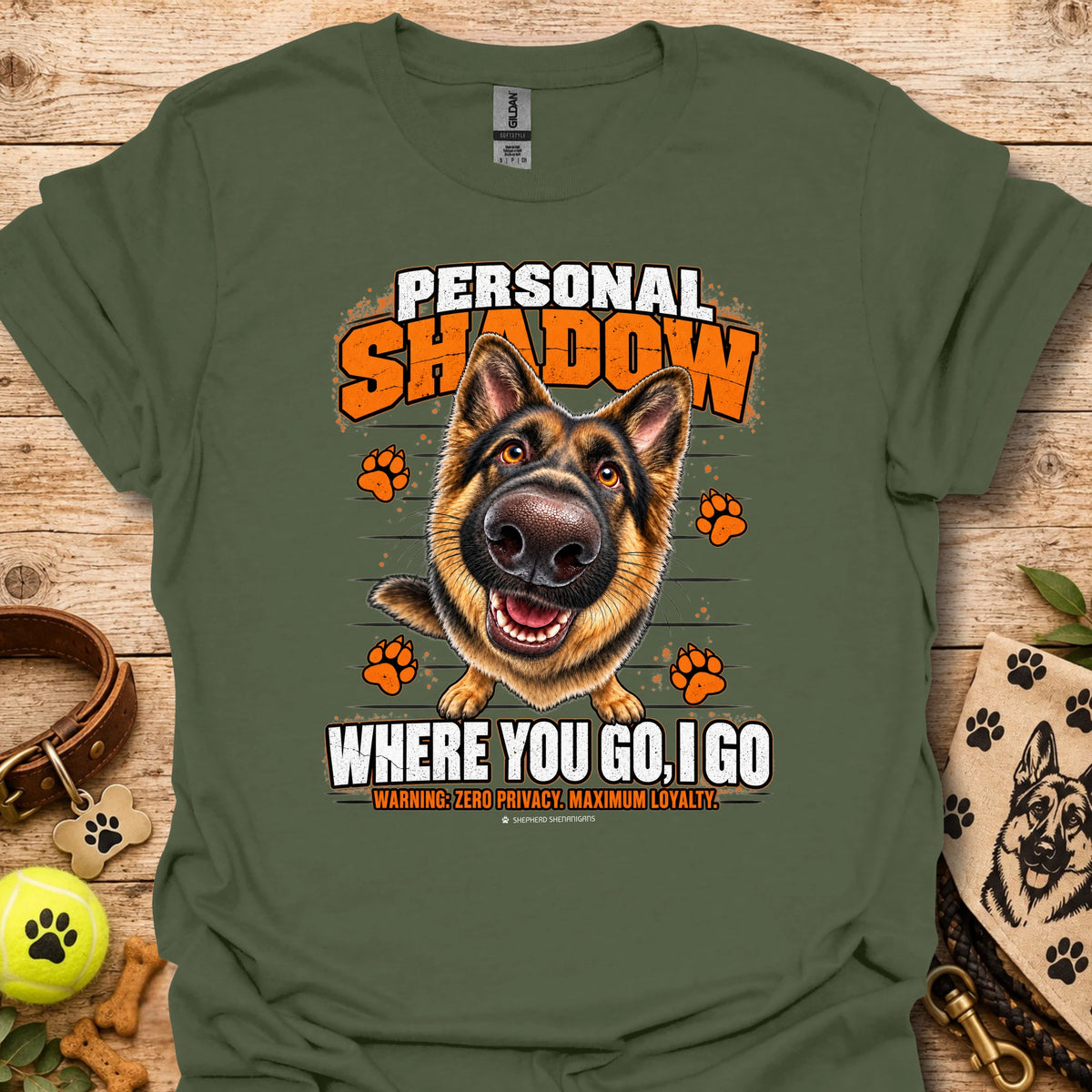 Military green T-shirt with a German shepherd graphic, orange paw prints and bold slogan