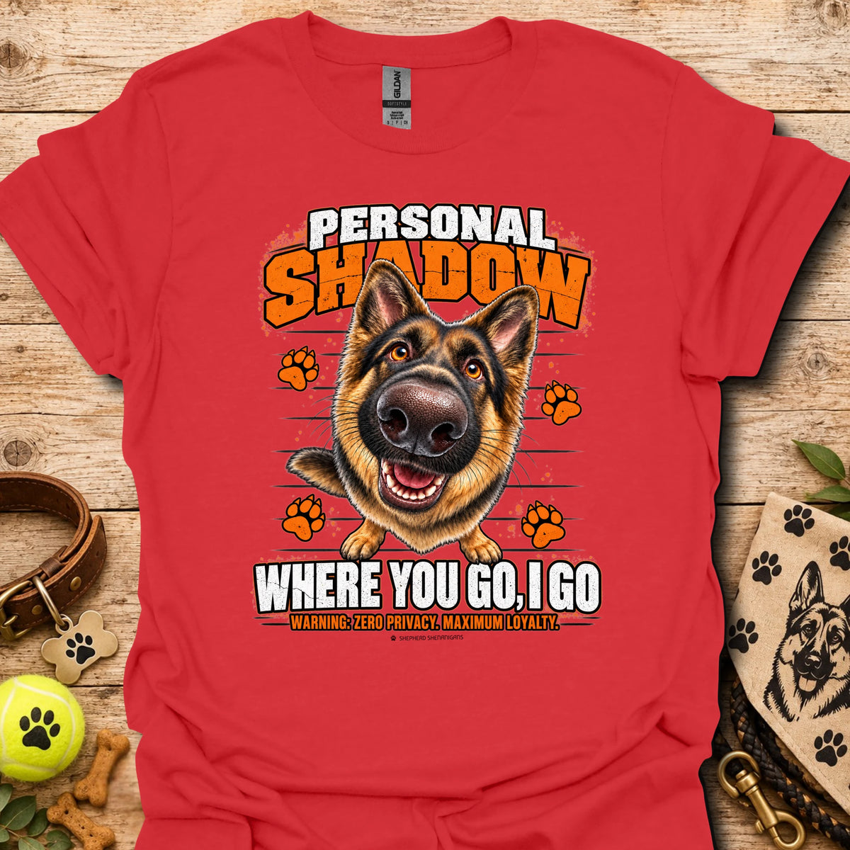 Red T-shirt with a German shepherd graphic, orange paw prints and bold slogan