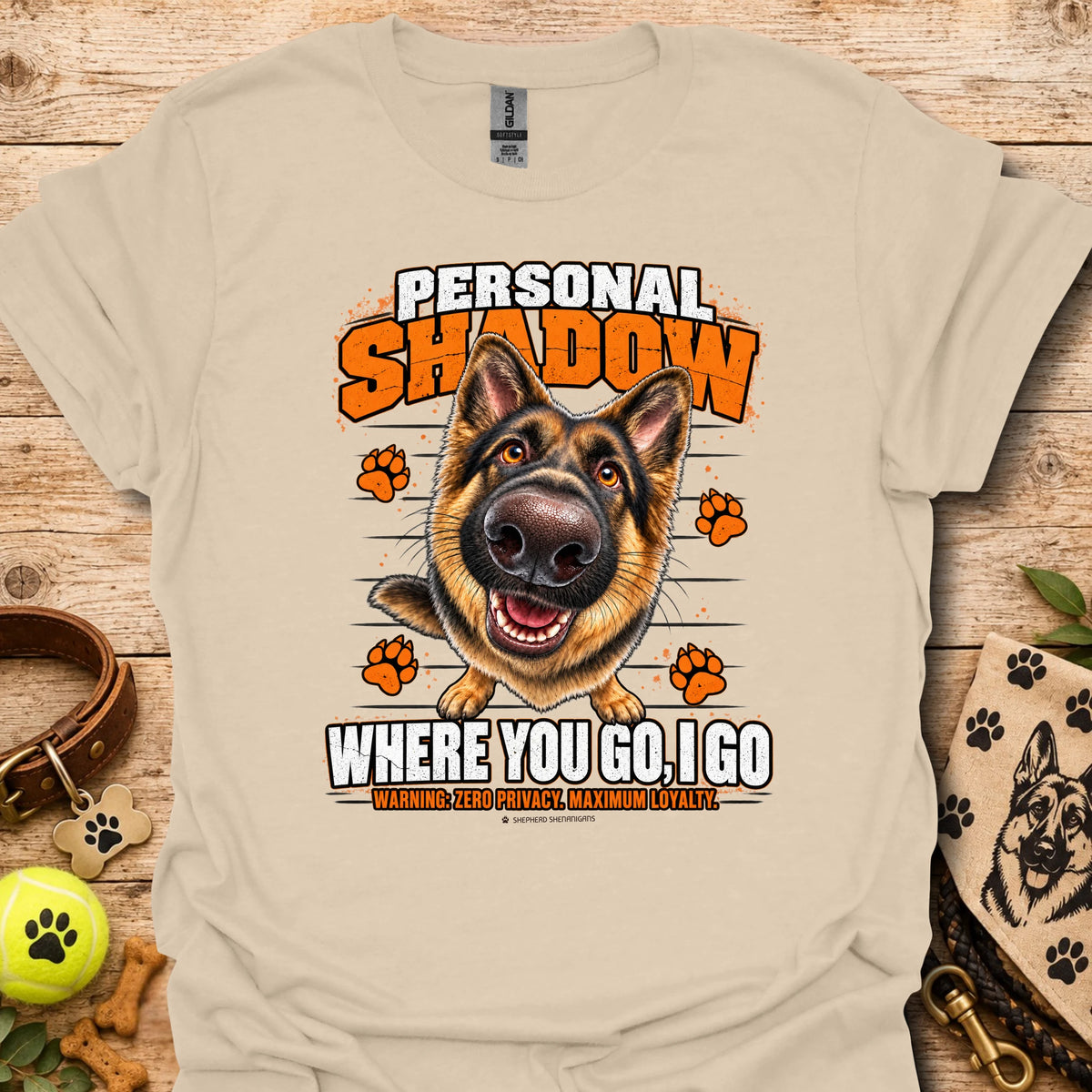 Sand T-shirt with a German shepherd graphic, orange paw prints and bold slogan