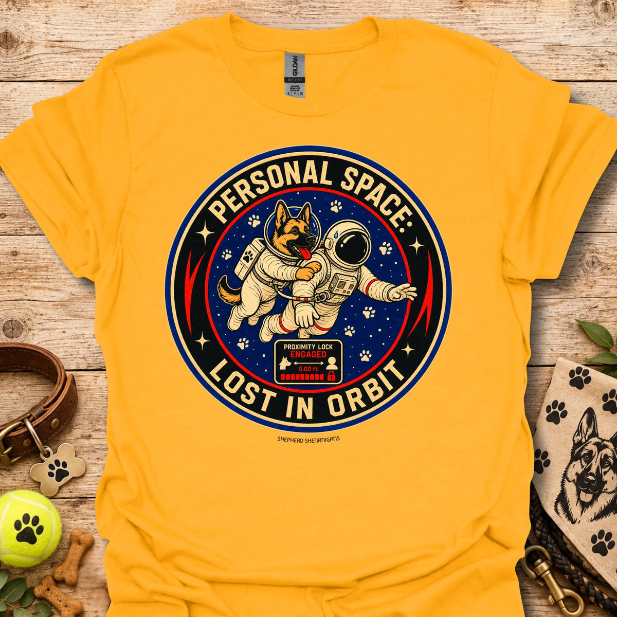 Gold t-shirt with astronaut dog graphic and circular 'Lost in Orbit' text