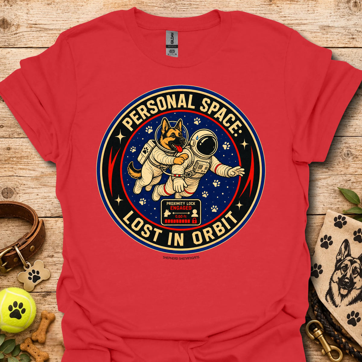 Red t-shirt with astronaut dog graphic and circular 'Lost in Orbit' text