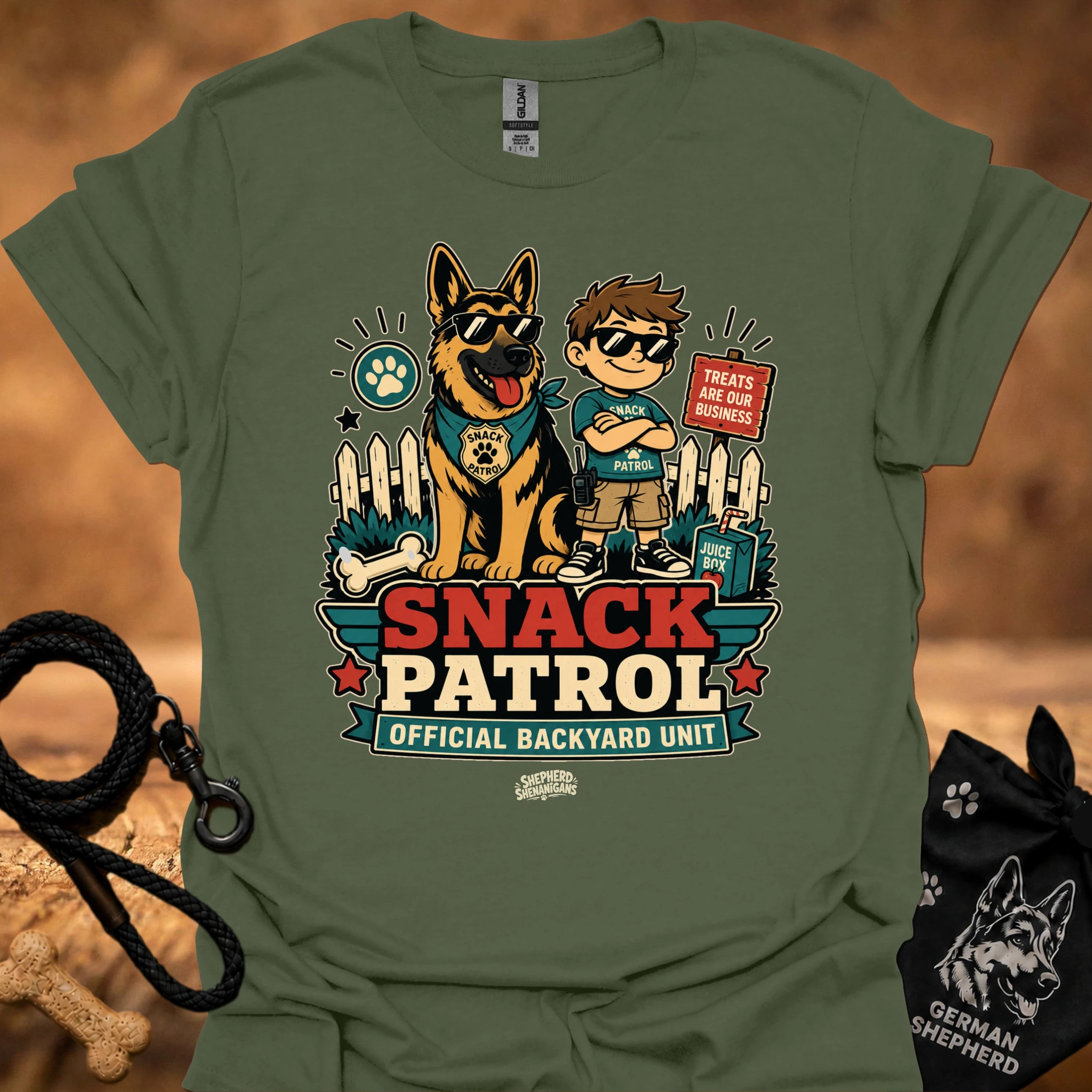 Military green graphic T-shirt with dog and boy print, Snack Patrol front text, crew neck.
