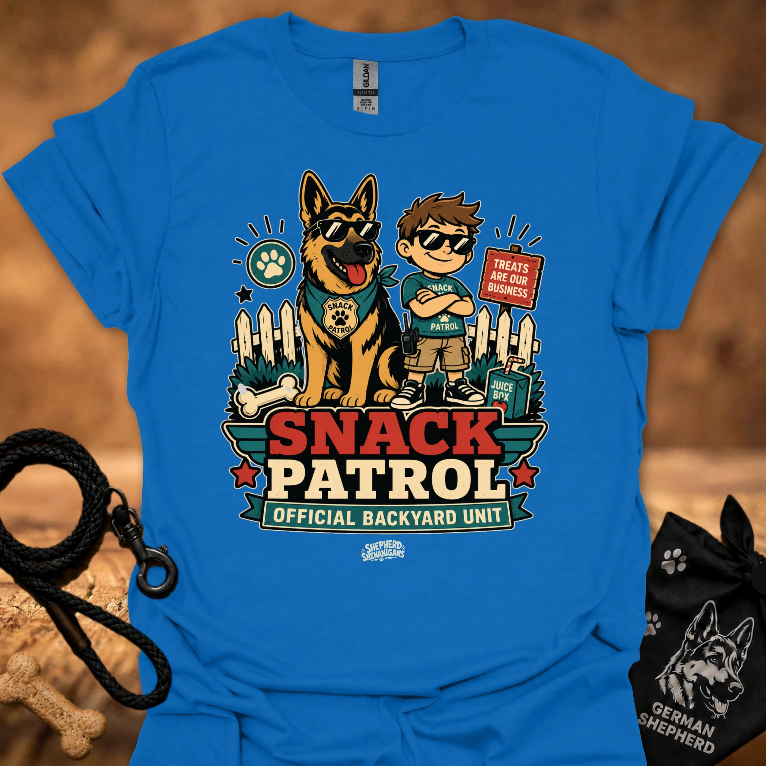 Royal blue graphic T-shirt with dog and boy print, Snack Patrol front text, crew neck.