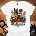 White graphic T-shirt with dog and boy print, Snack Patrol front text, crew neck.
