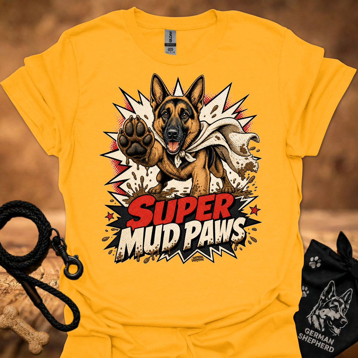 Gold graphic T-shirt with German shepherd and paw; “Super Mud Paws” print.