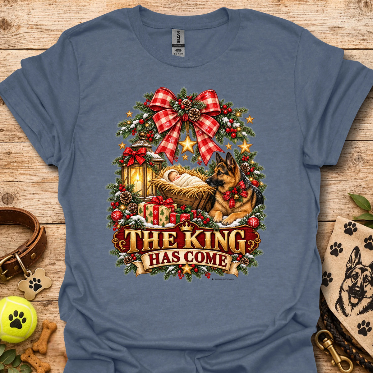 Heather indigo holiday graphic T-shirt with wreath, dog, and “THE KING HAS COME” print