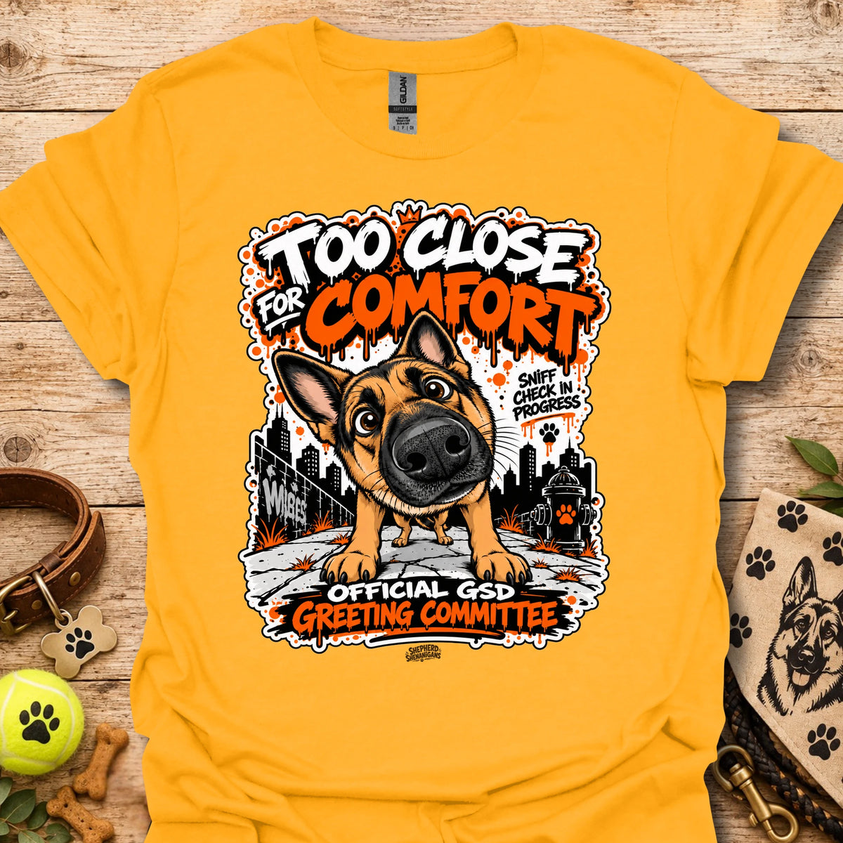 Gold dog graphic t-shirt with front print and “Too Close for Comfort” text