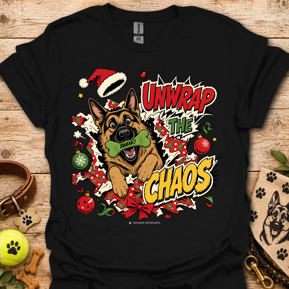 Black graphic dog t-shirt with "Unwrap the Chaos" text and Santa hat