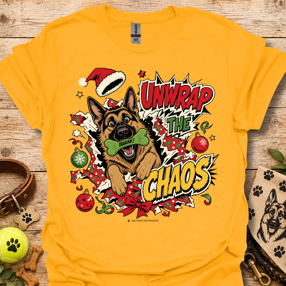 Gold graphic dog t-shirt with "Unwrap the Chaos" text and Santa hat