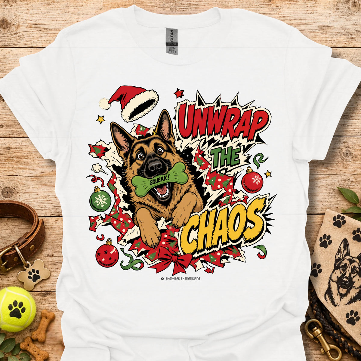 White graphic dog t-shirt with "Unwrap the Chaos" text and Santa hat