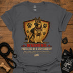 Charcoal gray dog graphic T-shirt with shield, paw prints, and “Warning” text