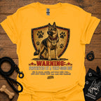 Gold dog graphic T-shirt with shield, paw prints, and “Warning” text