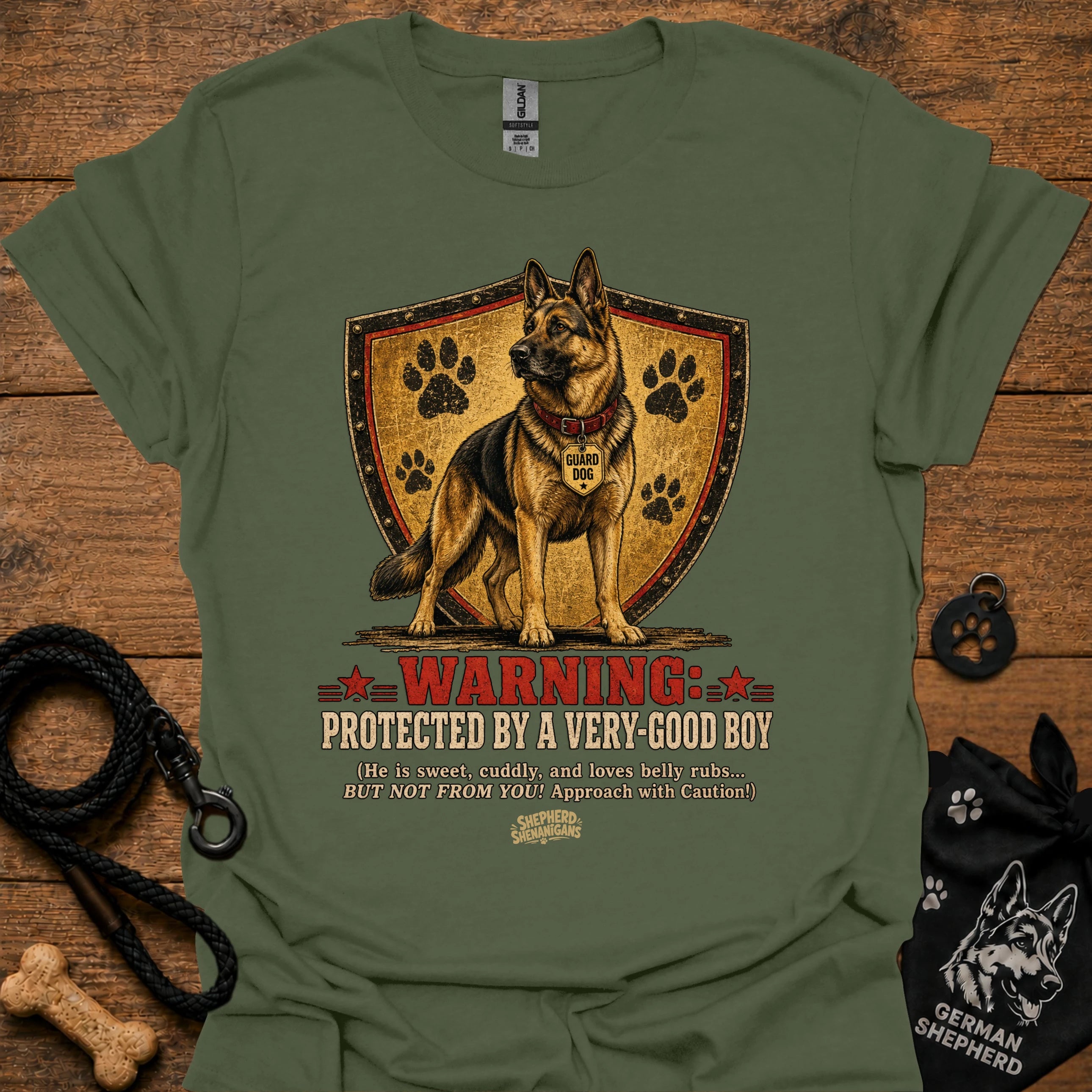 Military green dog graphic T-shirt with shield, paw prints, and “Warning” text