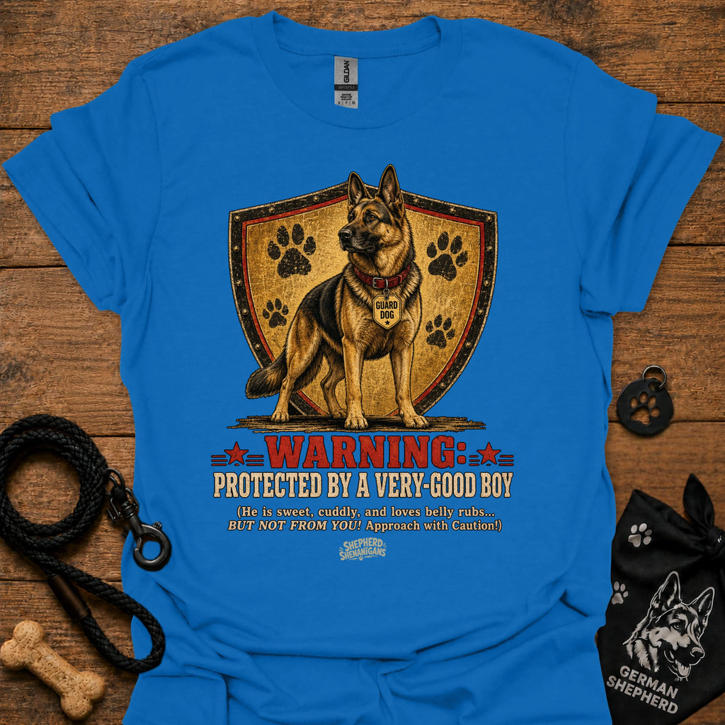 Royal blue dog graphic T-shirt with shield, paw prints, and “Warning” text