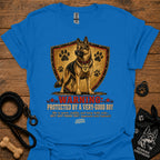 Royal blue dog graphic T-shirt with shield, paw prints, and “Warning” text