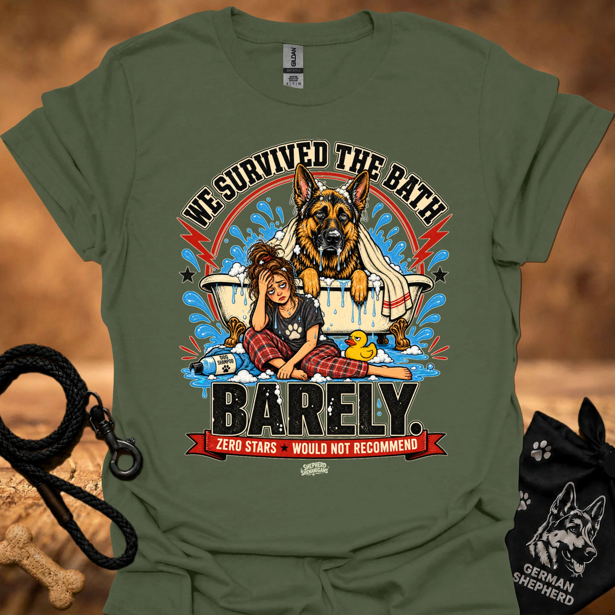 Military green T-shirt with large dog-and-girl cartoon graphic, crew neck.