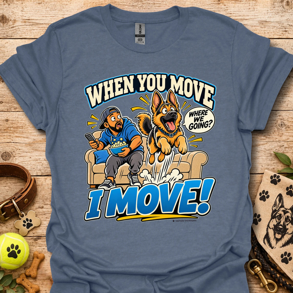 Heather indigo T-shirt with a cartoon man and dog leaping from a couch and bold slogan text.