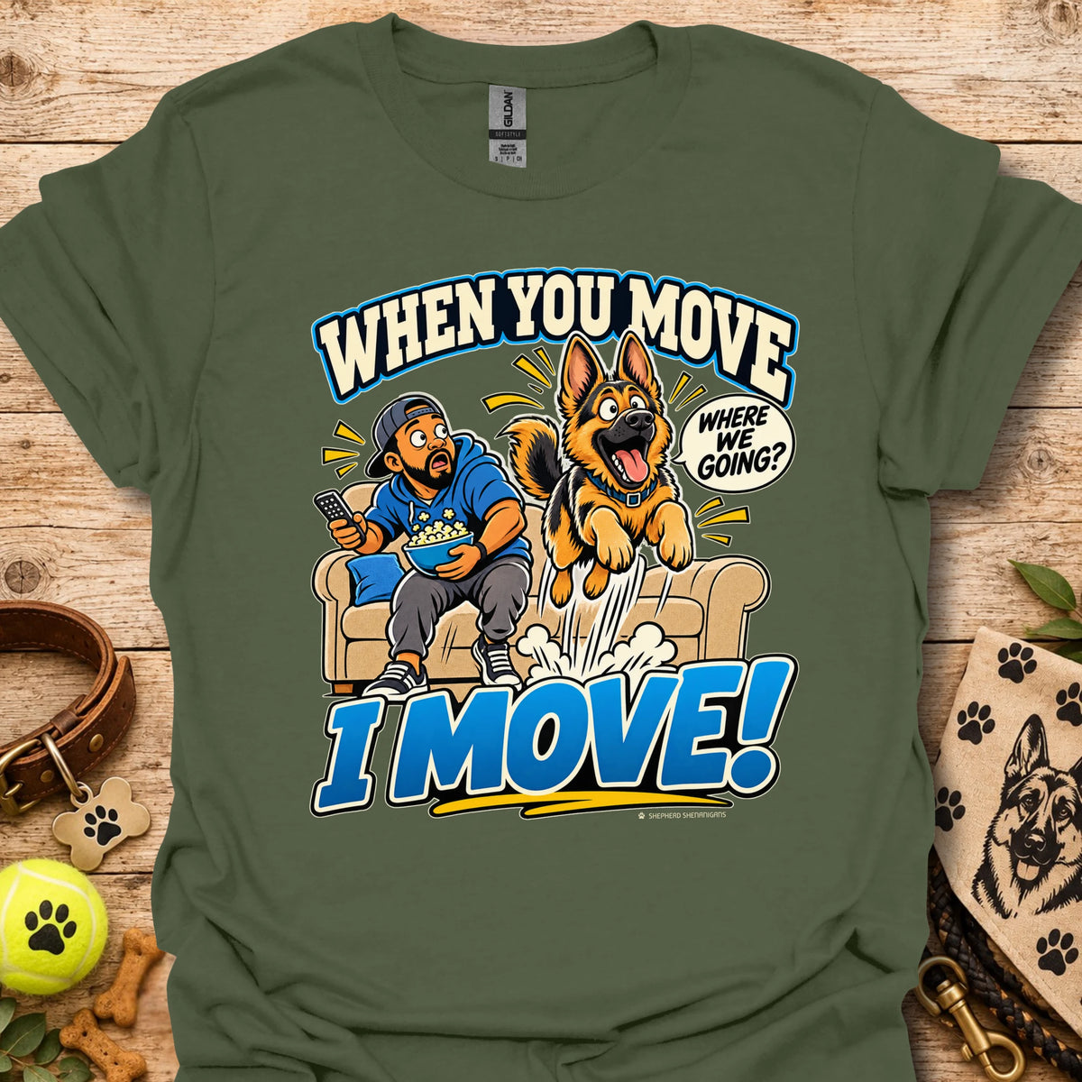 Military green T-shirt with a cartoon man and dog leaping from a couch and bold slogan text.