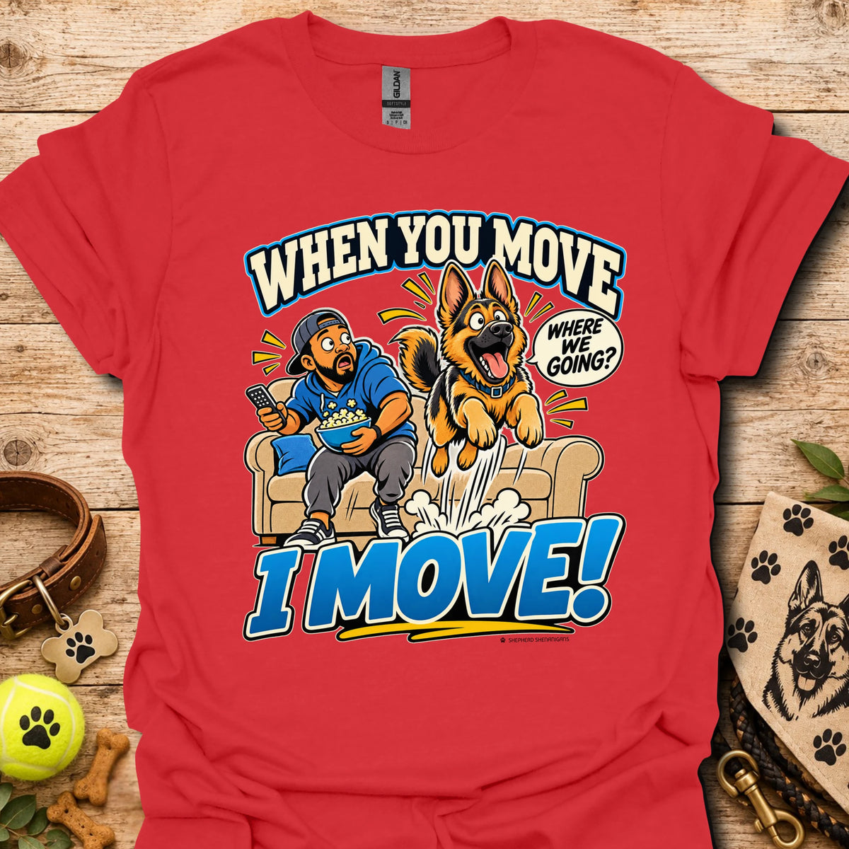 Red T-shirt with a cartoon man and dog leaping from a couch and bold slogan text.