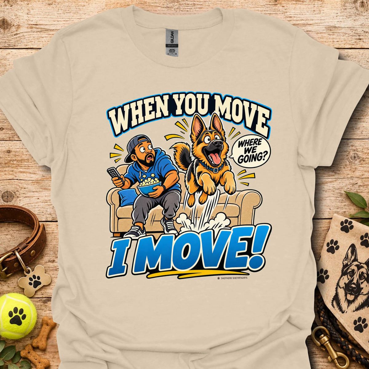 Sand T-shirt with a cartoon man and dog leaping from a couch and bold slogan text.
