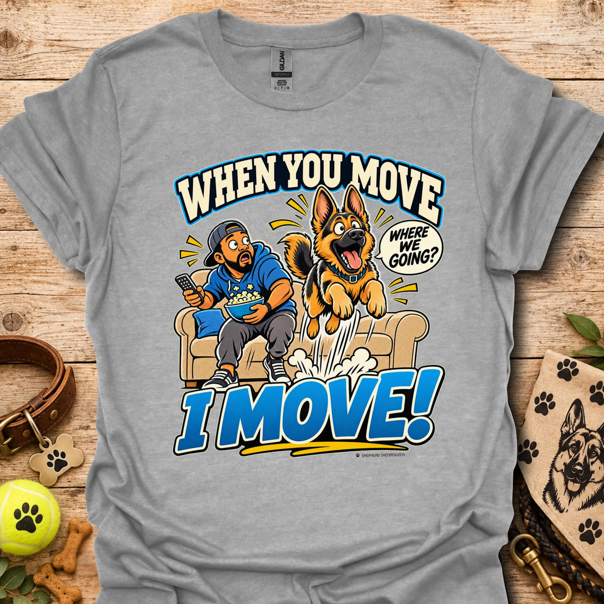 Sport grey T-shirt with a cartoon man and dog leaping from a couch and bold slogan text.