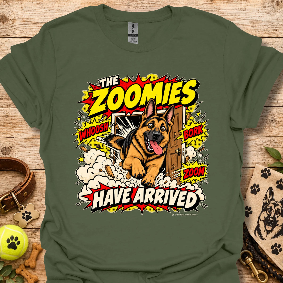 Military green T-shirt with playful dog graphic and 'THE ZOOMIES HAVE ARRIVED' text